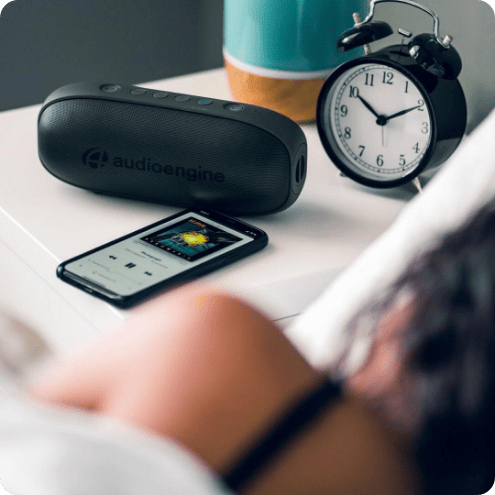 audioengine portable speaker next to alarm clock
