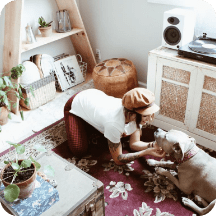 Woman petting dog with audioengine speaker in the background